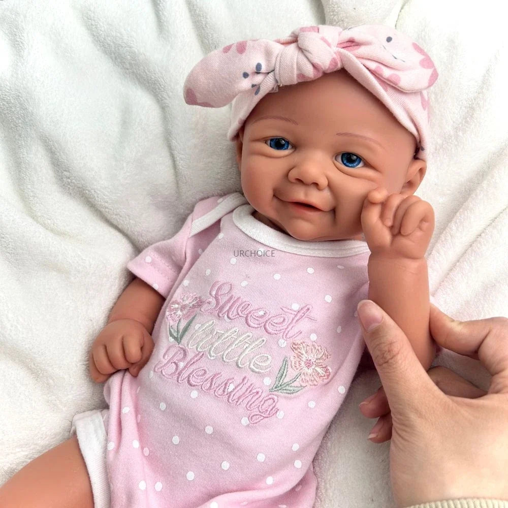 Luna, a smiling full silicone reborn baby girl with blue eyes