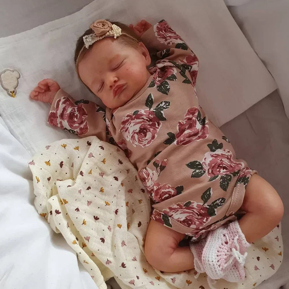 Finn, a 19 inch sleeping reborn baby doll with a soft vinyl head and limbs and closed eyes