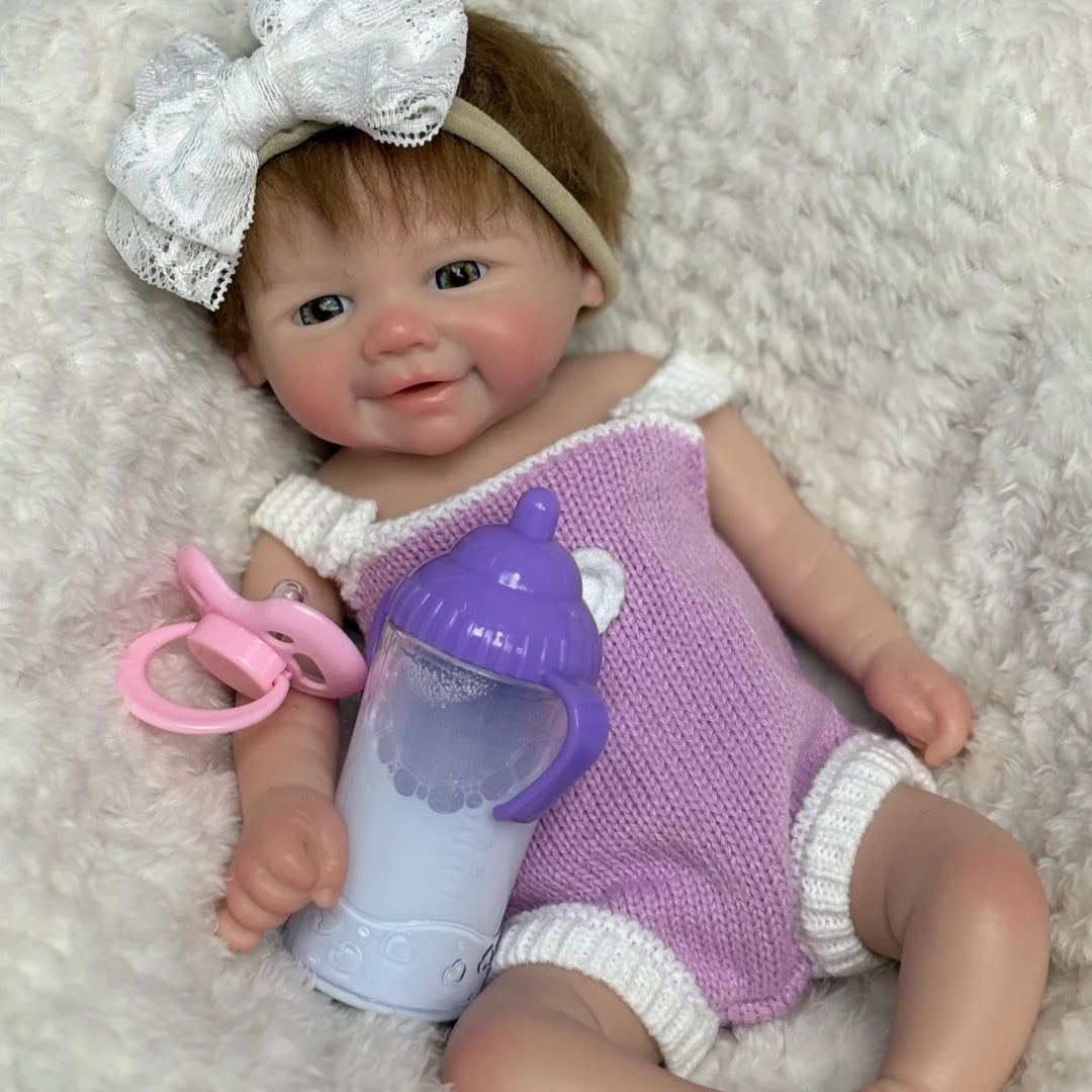 Lottie smiling with a feeding bottle beside her