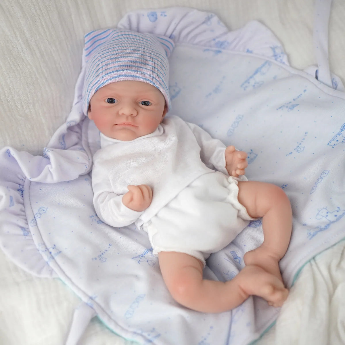 Ivy boy micro preemie in a blue striped hat and white outfit