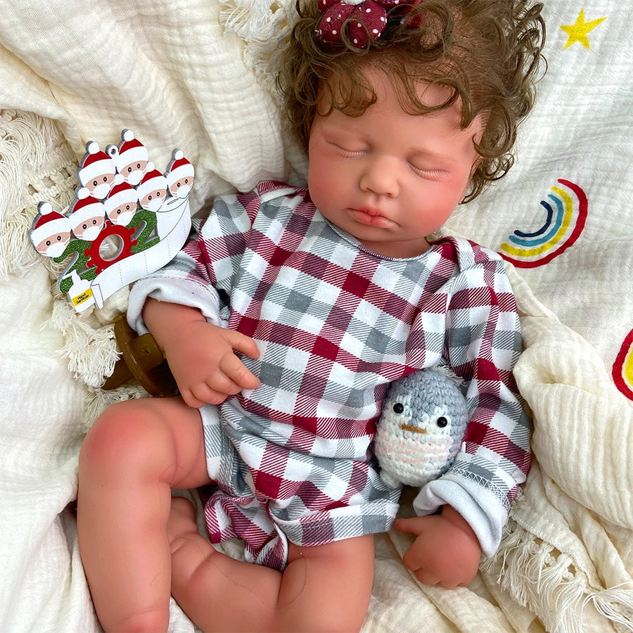 Noelle, a 20 inch full silicone sleeping reborn baby girl with rooted curly brown hair