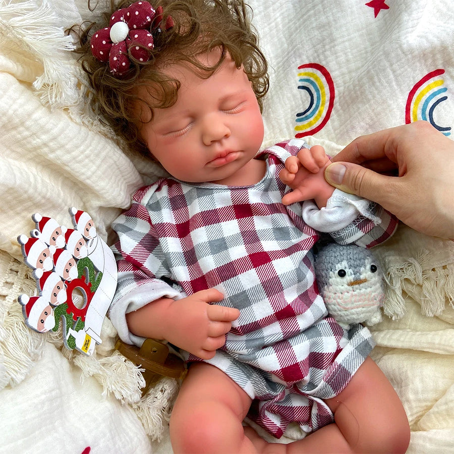 Noelle asleep on a cream blanket, a hand touching her cheek