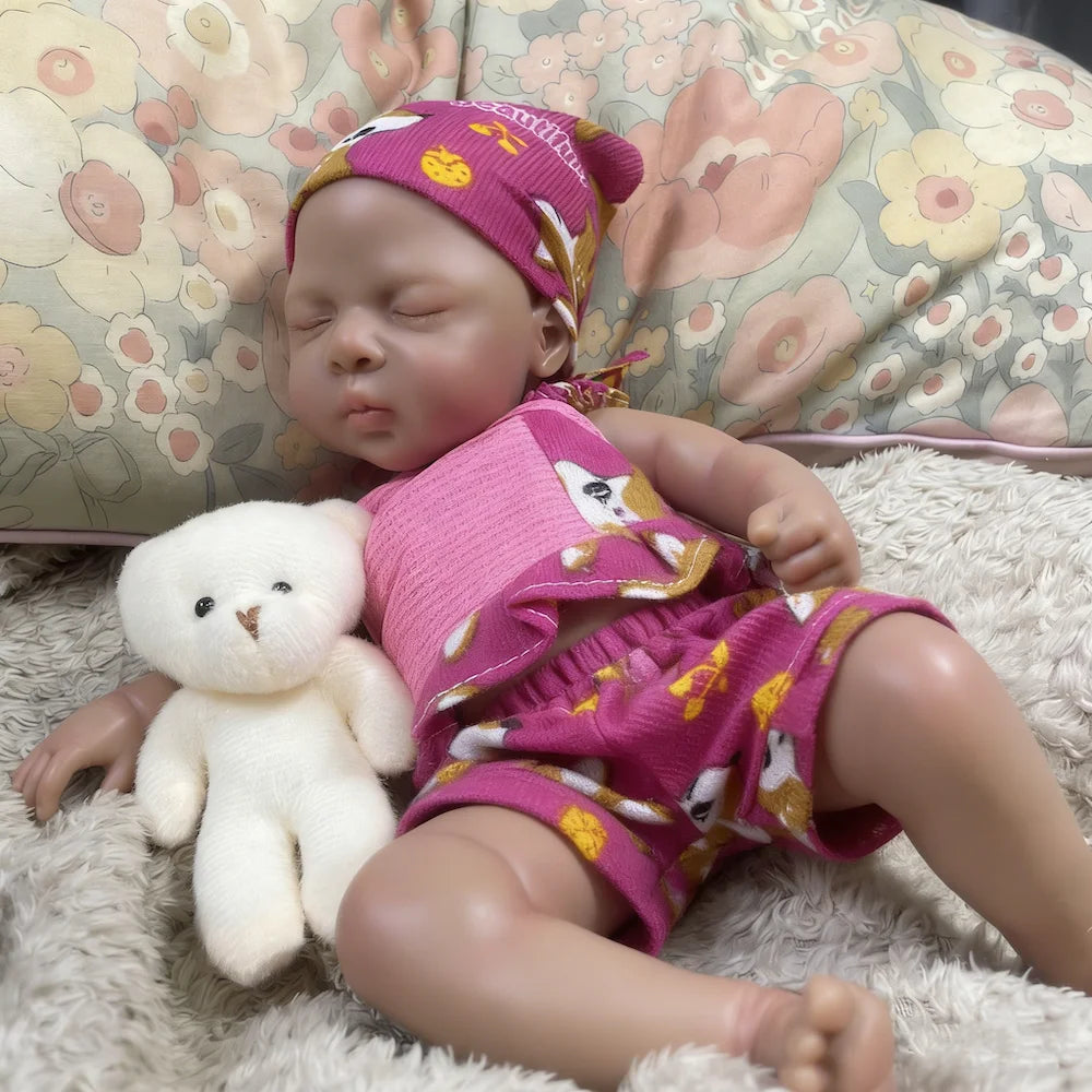 Nia mini silicone reborn sleeping beside a white teddy bear (bear not included)
