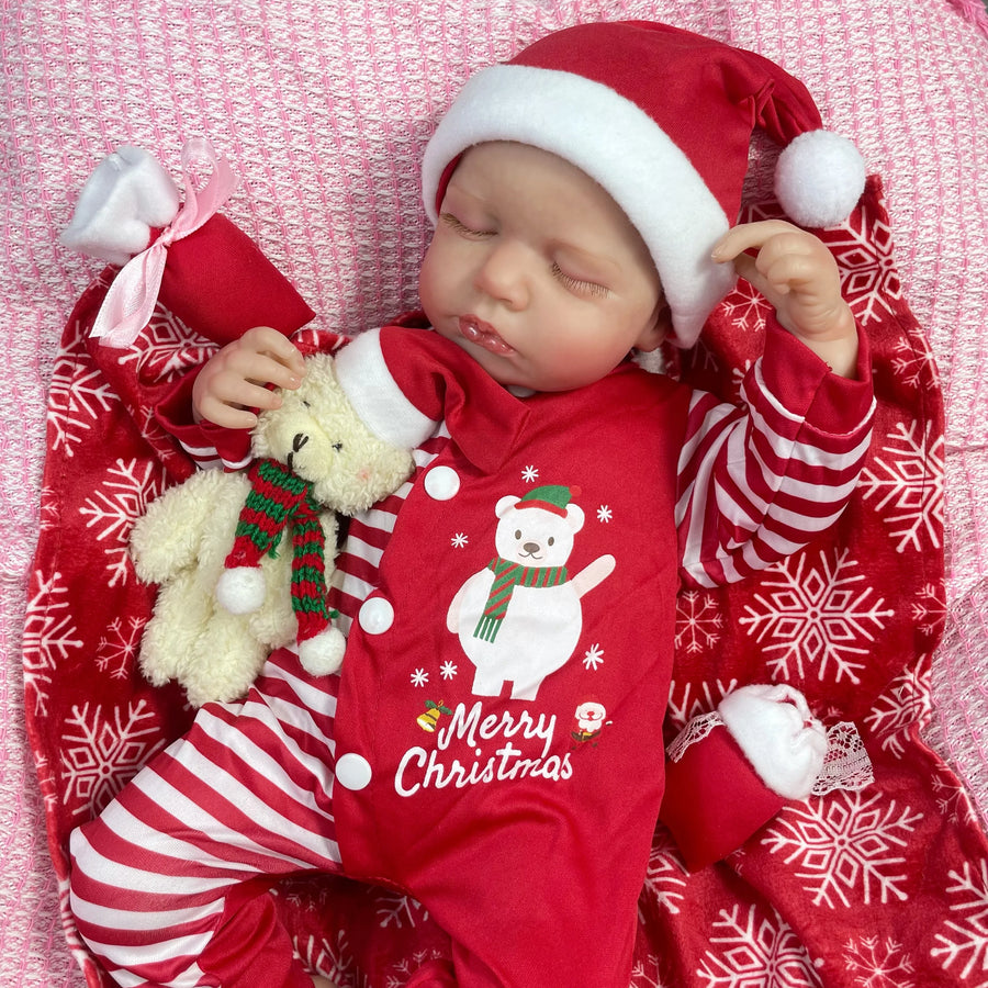 Holly asleep on a red snowflake blanket