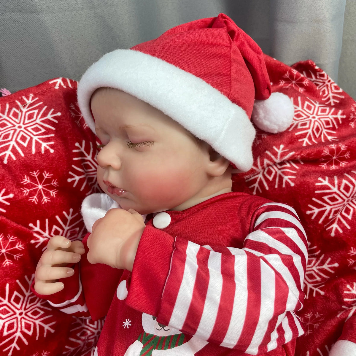 Side view of Holly sleeping in her Santa hat